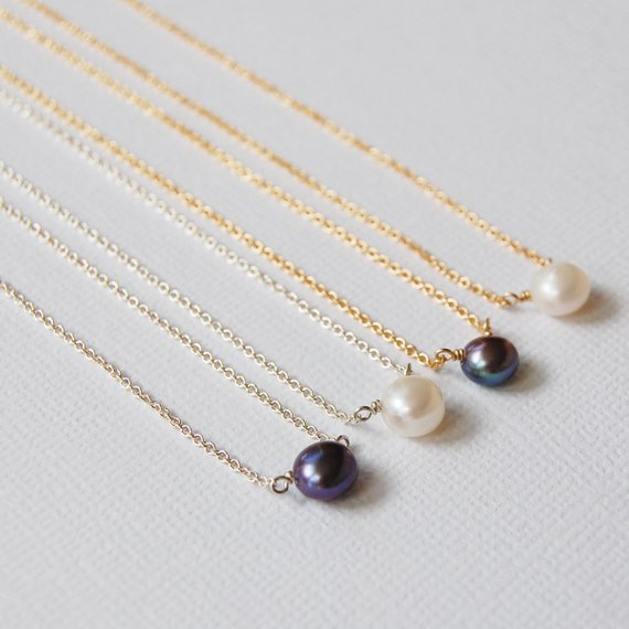 Four pearl necklaces, alternating grey and white pearls, are lined up in a row. Two have sterling silver chains and the other two have 14k gold filled chains.
